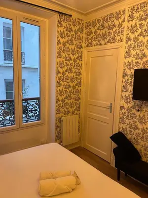 Un ou plusieurs lits dans un hébergement de l'établissement BLACK & WHITE - CHIC & PETIT MAISON- Pigalle 9eme