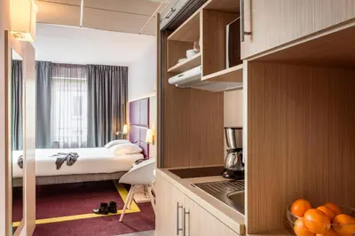 Un ou plusieurs lits dans un hébergement de l'établissement Aparthotel Adagio Paris Malakoff Chatillon