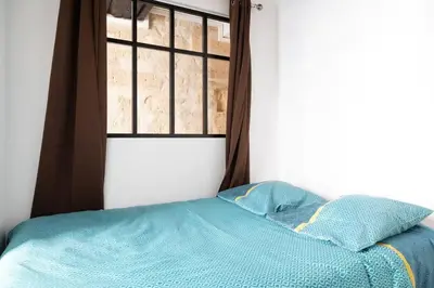 Un ou plusieurs lits dans un hébergement de l'établissement Appartement 2 chambres Lyonnais