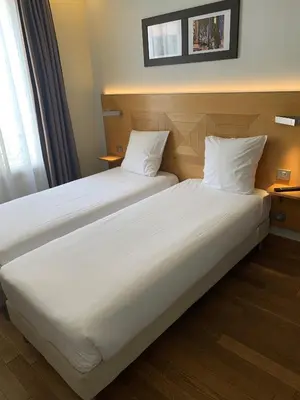 Un ou plusieurs lits dans un hébergement de l'établissement Hôtel Eiffel XV