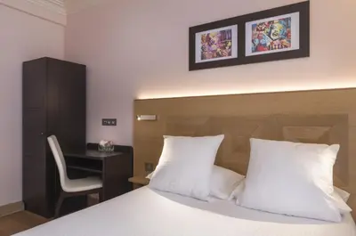 Un ou plusieurs lits dans un hébergement de l'établissement Hôtel Eiffel XV