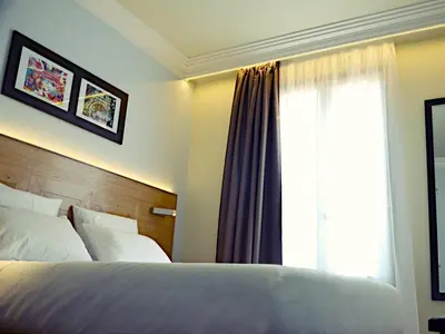 Un ou plusieurs lits dans un hébergement de l'établissement Hôtel Eiffel XV