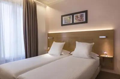 Un ou plusieurs lits dans un hébergement de l'établissement Hôtel Eiffel XV