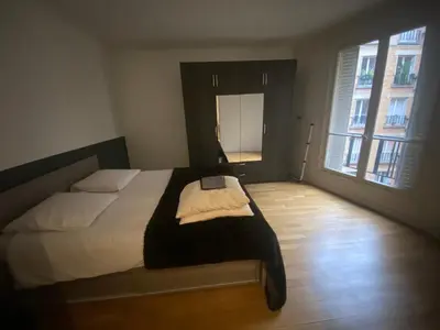 Un ou plusieurs lits dans un hébergement de l'établissement Petit coin de paradis Paris 16