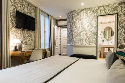 Un ou plusieurs lits dans un hébergement de l'établissement Hôtel Jardin Le Bréa