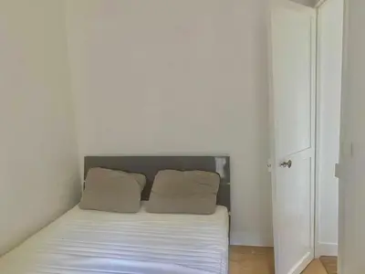Un ou plusieurs lits dans un hébergement de l'établissement Bel appartement Montparnasse 70m2