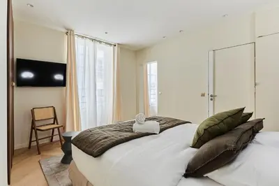 Un ou plusieurs lits dans un hébergement de l'établissement Apartment Champs Elysée bu Studio prestige