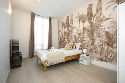 Un ou plusieurs lits dans un hébergement de l'établissement Nets Inn Apartments - Daumesnil