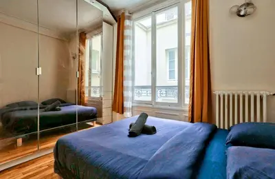 Un ou plusieurs lits dans un hébergement de l'établissement Arc de Triomphe Superbe Appartement Paris Free Netflix