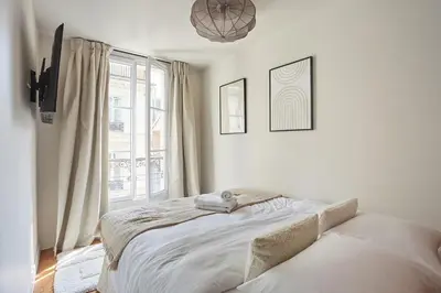 Un ou plusieurs lits dans un hébergement de l'établissement Apart hotel Centre de Paris by Studio prestige