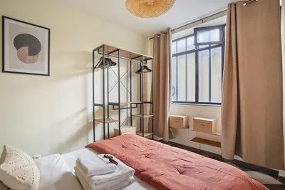Un ou plusieurs lits dans un hébergement de l'établissement Apartment Center of Paris by Studio prestige