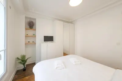 Un ou plusieurs lits dans un hébergement de l'établissement Mgic Apartment 4p Montmartre