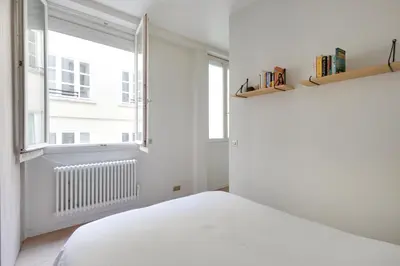 Un ou plusieurs lits dans un hébergement de l'établissement Appartement Neuf Saint-Honoré - Tuileries