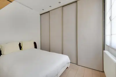 Un ou plusieurs lits dans un hébergement de l'établissement Appartement Neuf Saint-Honoré - Tuileries
