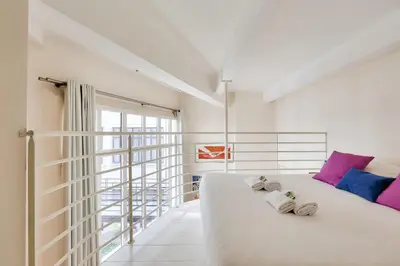 Un ou plusieurs lits dans un hébergement de l'établissement Mini-loft de charme au coeur de Paris