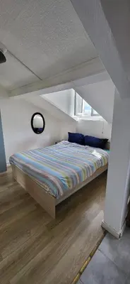 Un ou plusieurs lits dans un hébergement de l'établissement Cozy studio Clichy Levallois