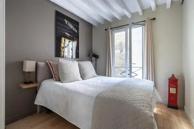 Un ou plusieurs lits dans un hébergement de l'établissement Cosy central place Paris