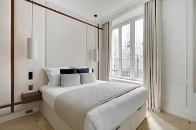 Un ou plusieurs lits dans un hébergement de l'établissement TheLander - Serviced Apartments in Louvre - Rivoli