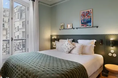 Un ou plusieurs lits dans un hébergement de l'établissement Paris Home Collection Serviced Apartments in Opéra - Rue Saint-Lazare
