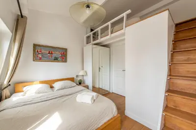 Un ou plusieurs lits dans un hébergement de l'établissement Geranimus 36B : Hearth of Paris