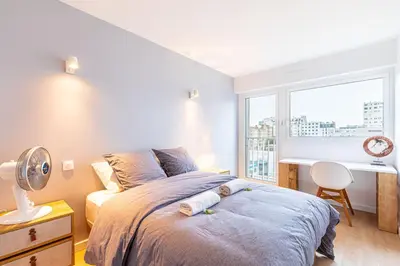 Un ou plusieurs lits dans un hébergement de l'établissement GuestReady - Apt avec Balcon à la Place d'Italie