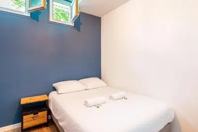 Un ou plusieurs lits dans un hébergement de l'établissement GuestReady - Apt de Charme près de la Tour Eiffel