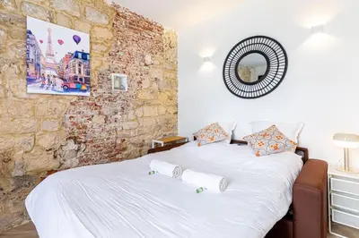 Un ou plusieurs lits dans un hébergement de l'établissement GuestReady - Charming Getaway in Le Marais