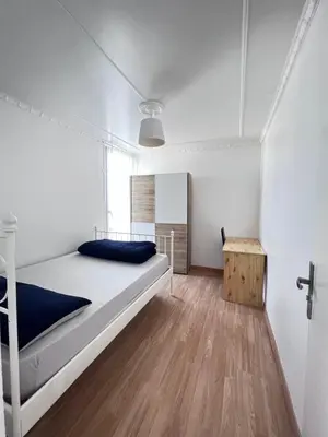 Un ou plusieurs lits dans un hébergement de l'établissement Bel appartement proche Paris métro 4
