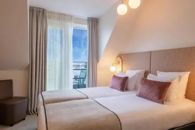 Un ou plusieurs lits dans un hébergement de l'établissement Helussi Hôtel