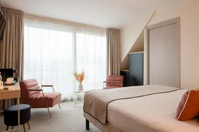 Un ou plusieurs lits dans un hébergement de l'établissement Helussi Hôtel