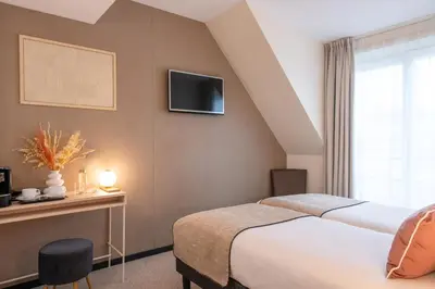 Un ou plusieurs lits dans un hébergement de l'établissement Helussi Hôtel