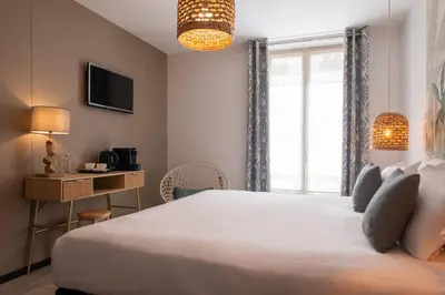 Un ou plusieurs lits dans un hébergement de l'établissement Helussi Hôtel