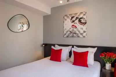 Un ou plusieurs lits dans un hébergement de l'établissement Helussi Hôtel