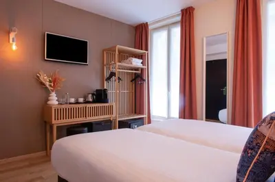 Un ou plusieurs lits dans un hébergement de l'établissement Helussi Hôtel