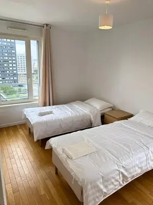 Un ou plusieurs lits dans un hébergement de l'établissement Magnifique Appart. spacieux 8P/ Défense-Courbevoie
