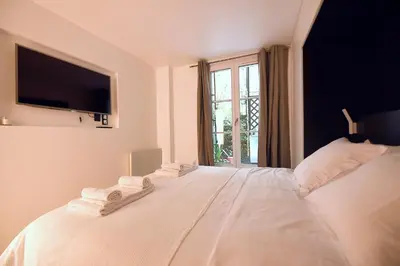 Un ou plusieurs lits dans un hébergement de l'établissement Cosy flat - Saint germain