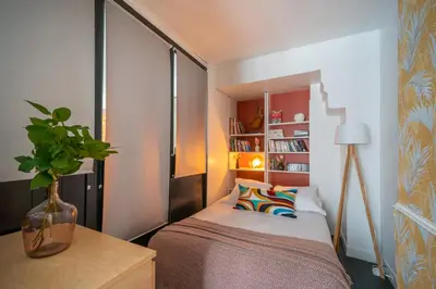 Un ou plusieurs lits dans un hébergement de l'établissement Spacious Family Apartment near Bastille & Marais