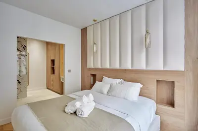 Un ou plusieurs lits dans un hébergement de l'établissement Apartment Centre de Paris by Studio prestige