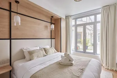 Un ou plusieurs lits dans un hébergement de l'établissement Apartment Centre de Paris by Studio prestige