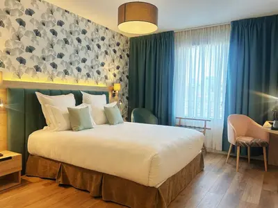 Un ou plusieurs lits dans un hébergement de l'établissement Hôtel Oden Paris Ivry