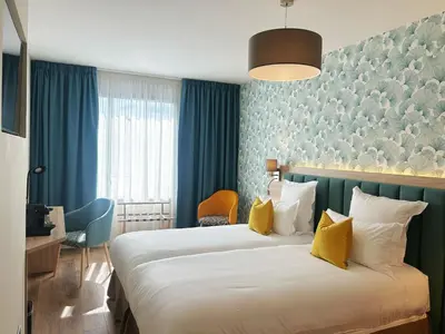 Un ou plusieurs lits dans un hébergement de l'établissement Hôtel Oden Paris Ivry