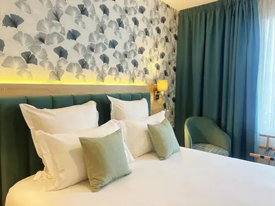 Un ou plusieurs lits dans un hébergement de l'établissement Hôtel Oden Paris Ivry