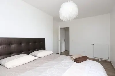 Un ou plusieurs lits dans un hébergement de l'établissement Paris-Stade De France 3 rooms Parking Metro