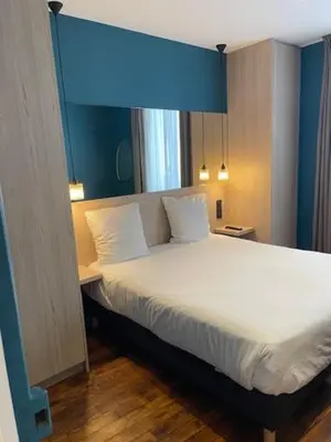 Un ou plusieurs lits dans un hébergement de l'établissement Les Appartements du Grand Hôtel Clichy Paris