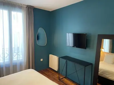 Un ou plusieurs lits dans un hébergement de l'établissement Les Appartements du Grand Hôtel Clichy Paris