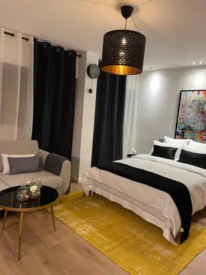 Un ou plusieurs lits dans un hébergement de l'établissement Cosy Studio paris 16 Victor Hugo