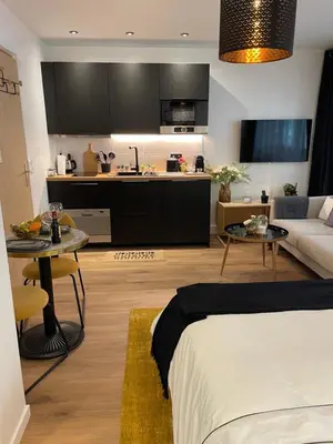 Un ou plusieurs lits dans un hébergement de l'établissement Cosy Studio paris 16 Victor Hugo