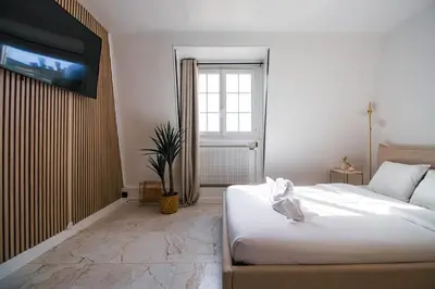 Un ou plusieurs lits dans un hébergement de l'établissement Typical Parisian Studio in Le Marais