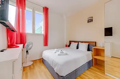 Un ou plusieurs lits dans un hébergement de l'établissement Cocon chaleureux aux portes de Paris