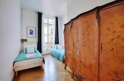Un ou plusieurs lits dans un hébergement de l'établissement Champs Élysées : Appartement 200 m2 avec balcon